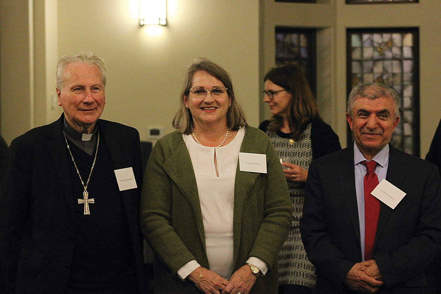 Dr. Sandra Keating gathers with speakers Cardinal Michael Fitzgerald and Dr. Zeki Saritoprak after the lectures.